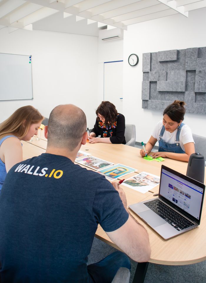 Crafting Captivating Headlines: Your awesome post title goes here A diverse group of professionals collaborate in a modern office setting, working on marketing strategies.